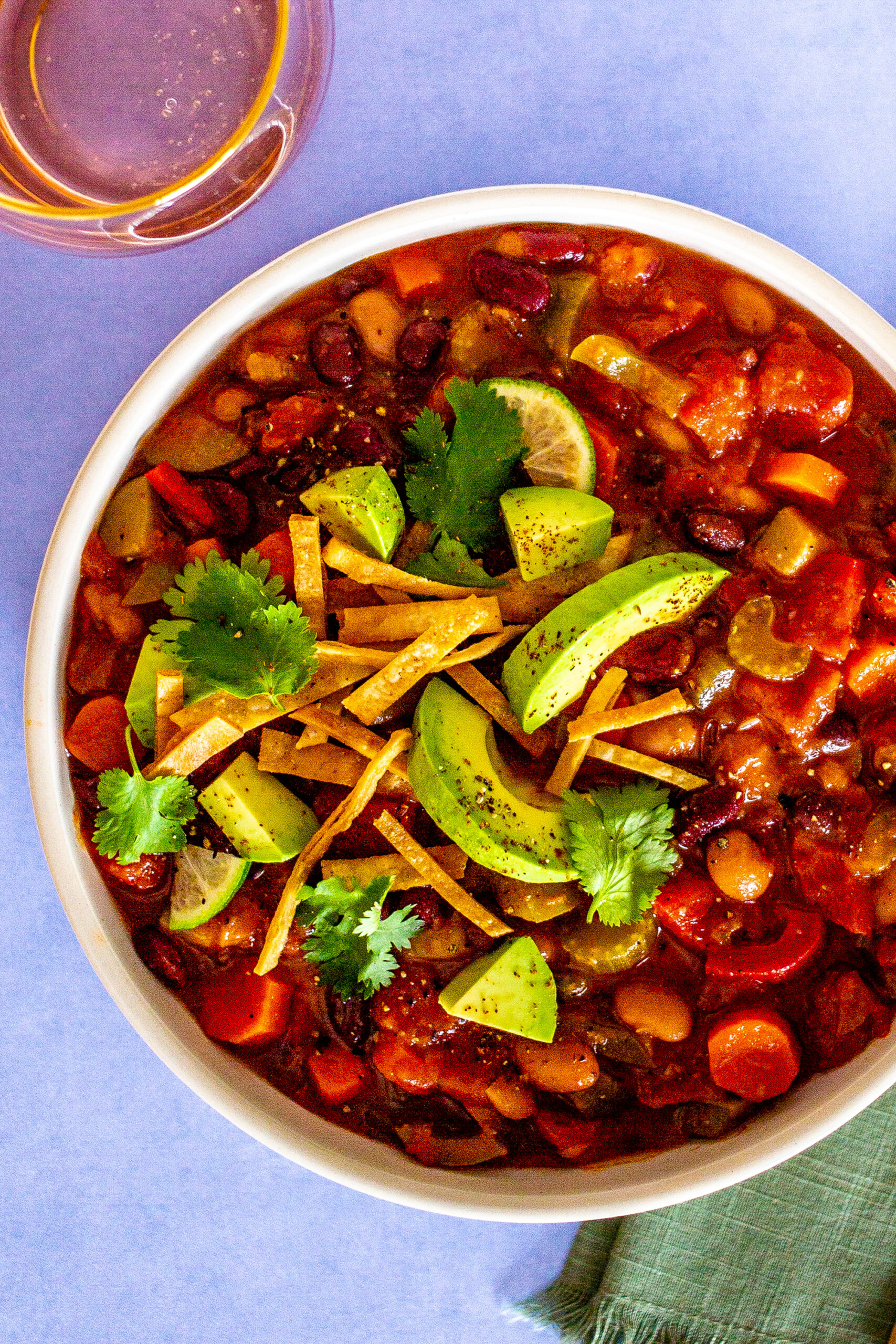 Bowl of chili with slices of avo